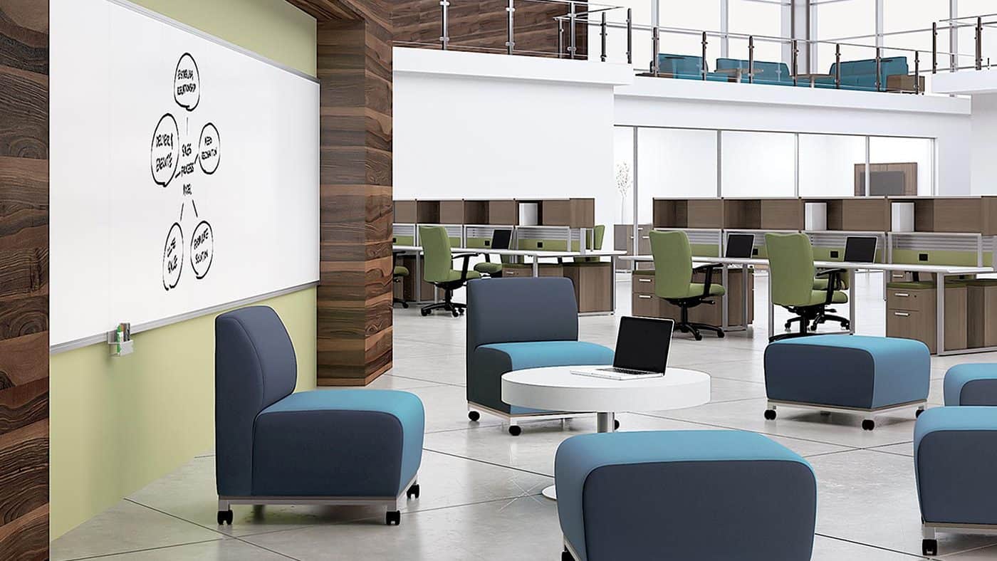 Large, two-level open office with meeting area including marker board and rolling chairs and ottomans