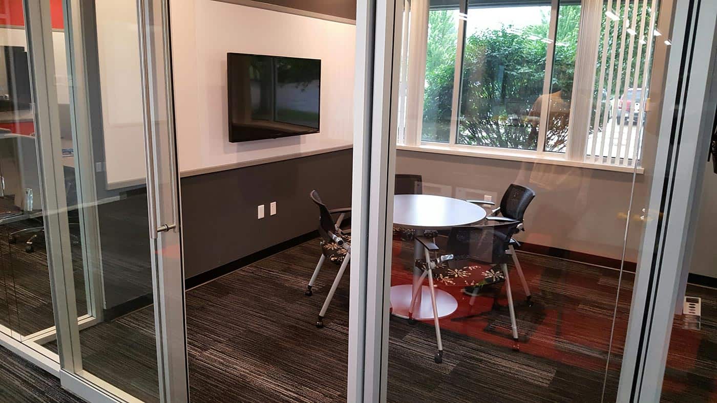 Small meeting room with sliding glass wall for audible privacy